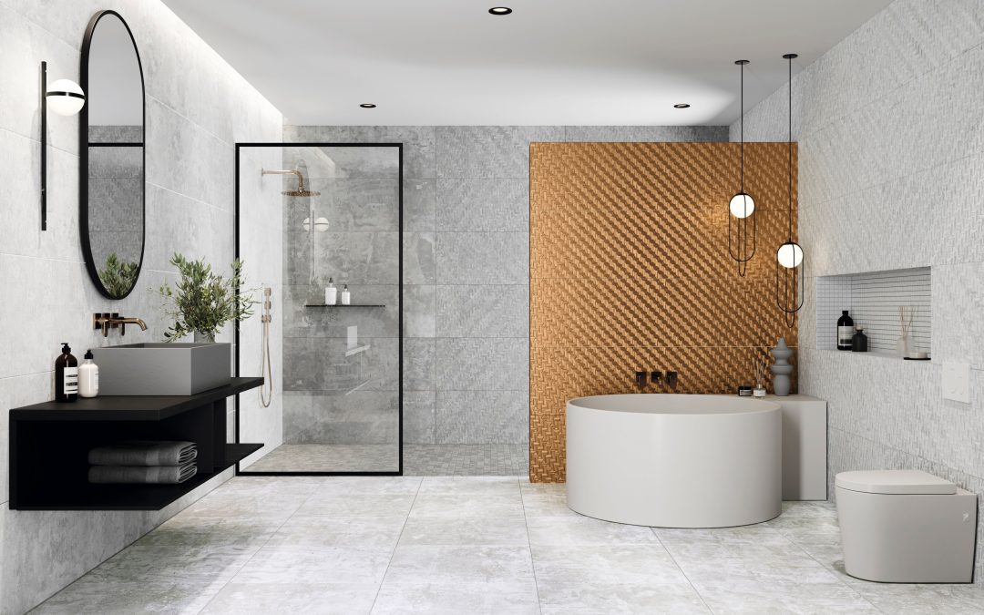 Modern bathroom featuring freestanding bath and walk-in shower with glass enclosure, grey tiles and gold accent wall.